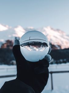 Preview wallpaper hand, ball, glass, mountains, optical illusion