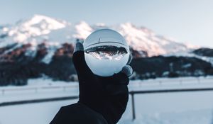 Preview wallpaper hand, ball, glass, mountains, optical illusion