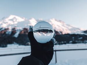 Preview wallpaper hand, ball, glass, mountains, optical illusion