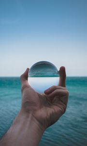 Preview wallpaper hand, ball, glass, reflection, distortion, sea