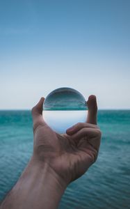 Preview wallpaper hand, ball, glass, reflection, distortion, sea