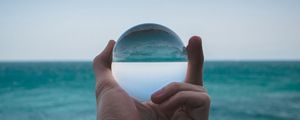 Preview wallpaper hand, ball, glass, reflection, distortion, sea