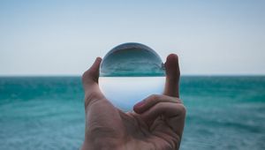 Preview wallpaper hand, ball, glass, reflection, distortion, sea