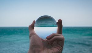 Preview wallpaper hand, ball, glass, reflection, distortion, sea