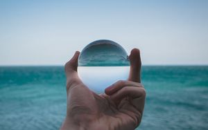 Preview wallpaper hand, ball, glass, reflection, distortion, sea