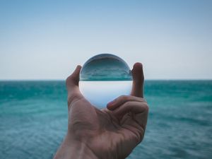 Preview wallpaper hand, ball, glass, reflection, distortion, sea