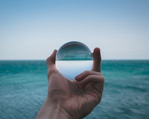 Preview wallpaper hand, ball, glass, reflection, distortion, sea
