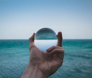 Preview wallpaper hand, ball, glass, reflection, distortion, sea