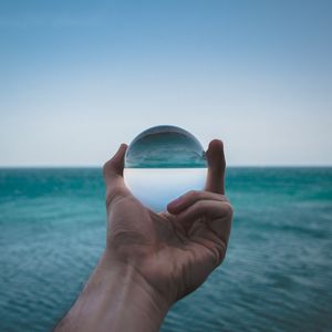 Preview wallpaper hand, ball, glass, reflection, distortion, sea