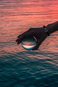 Preview wallpaper hand, ball, glass, reflection, water, waves