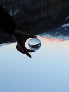 Preview wallpaper hand, ball, reflection, mountains