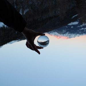 Preview wallpaper hand, ball, reflection, mountains