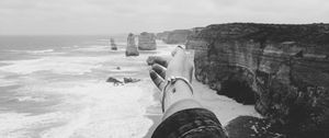 Preview wallpaper hand, coast, bw, cliffs, sea