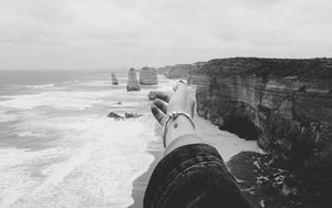 Preview wallpaper hand, coast, bw, cliffs, sea