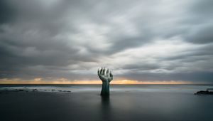 Preview wallpaper hand, coast, sand, clouds, wet