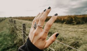 Preview wallpaper hand, fingers, rings, decoration, manicure, field, fence