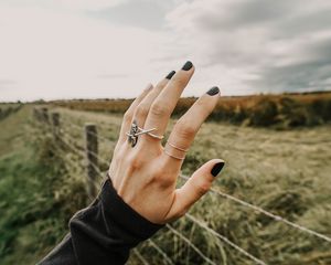 Preview wallpaper hand, fingers, rings, decoration, manicure, field, fence