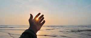 Preview wallpaper hand, fingers, sun, rays, sea, waves