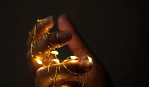 Preview wallpaper hand, garland, fingers, dark, glow