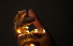 Preview wallpaper hand, garland, fingers, dark, glow