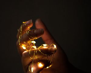 Preview wallpaper hand, garland, fingers, dark, glow