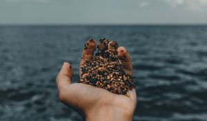 Preview wallpaper hand, pebble, sea, water, horizon