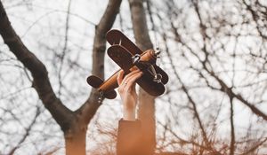 Preview wallpaper hand, plane, toy, trees, branches
