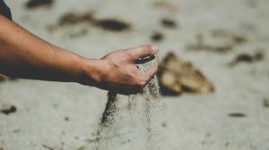 Preview wallpaper hand, sand, pour, beach