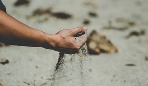 Preview wallpaper hand, sand, pour, beach