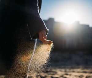 Preview wallpaper hand, sand, sunlight, glare