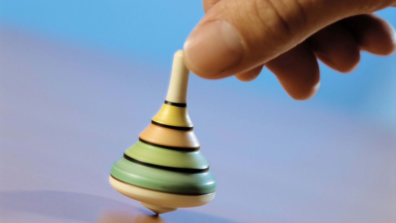 Wallpaper hand, spinning top, toy, blue background