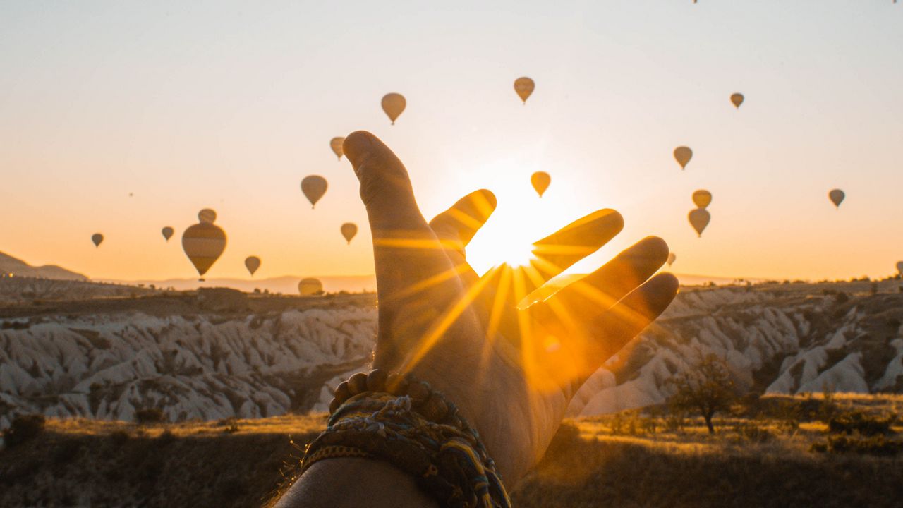 Wallpaper hand, sun, air balloons, mountains, sunrise