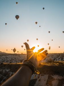 Preview wallpaper hand, sun, air balloons, mountains, sunrise