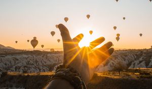 Preview wallpaper hand, sun, air balloons, mountains, sunrise
