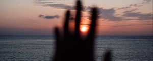 Preview wallpaper hand, sunset, horizon, sea, sky