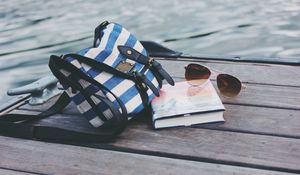 Preview wallpaper handbag, sunglasses, book, river
