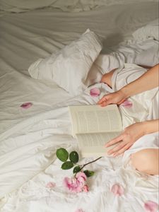 Preview wallpaper hands, book, flowers, petals, bed