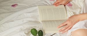 Preview wallpaper hands, book, flowers, petals, bed