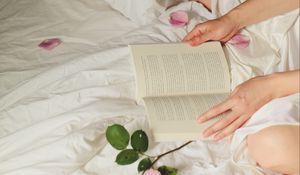 Preview wallpaper hands, book, flowers, petals, bed