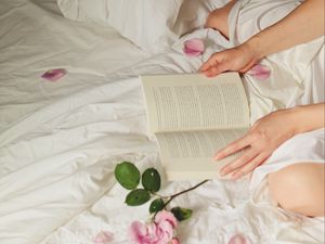 Preview wallpaper hands, book, flowers, petals, bed