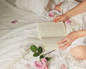 Preview wallpaper hands, book, flowers, petals, bed