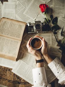 Preview wallpaper hands, cup, book, page, camera, flower