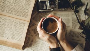 Preview wallpaper hands, cup, book, page, camera, flower