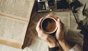 Preview wallpaper hands, cup, book, page, camera, flower