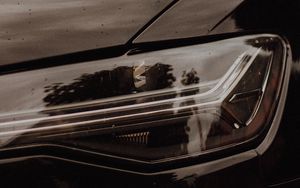Preview wallpaper headlight, car, black, wet, closeup