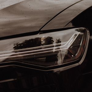 Preview wallpaper headlight, car, black, wet, closeup