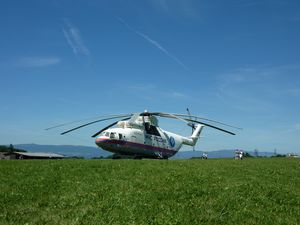 Preview wallpaper helicopter, mi-26, grass, russia, meadow, house, mountain, people