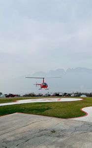 Preview wallpaper helicopter, runway, pad, fog, red