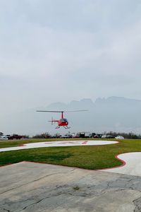 Preview wallpaper helicopter, runway, pad, fog, red