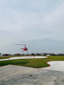 Preview wallpaper helicopter, runway, pad, fog, red